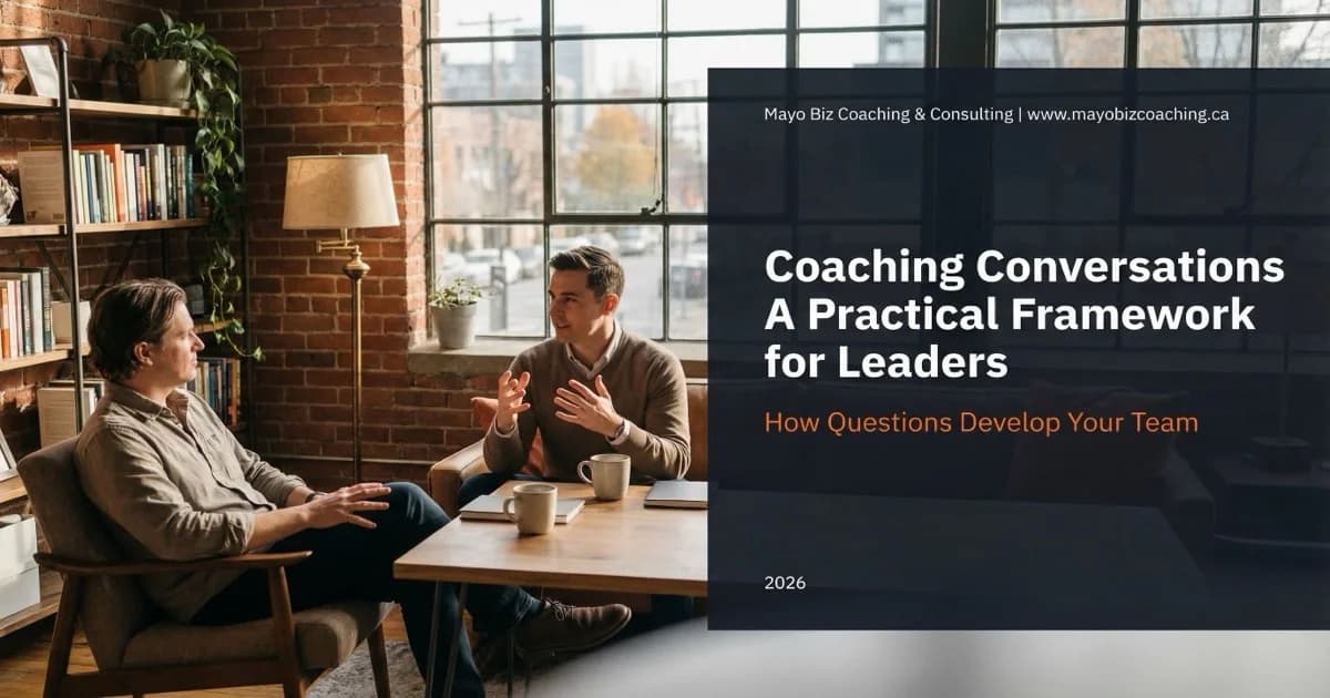 Leader listening attentively while a team member works through a challenge in a warm modern office